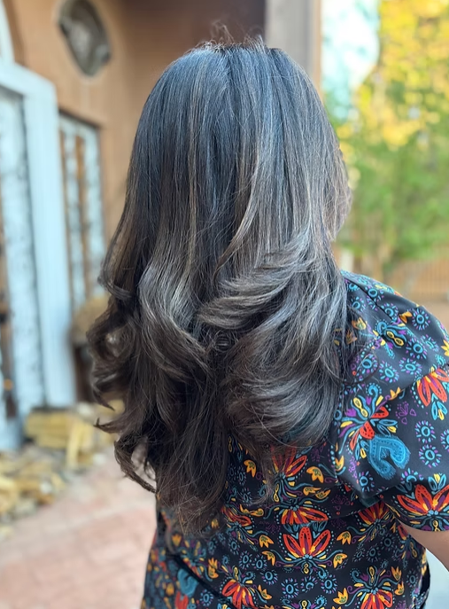 Long layered curly hair cut by expert Albuquerque hair stylist